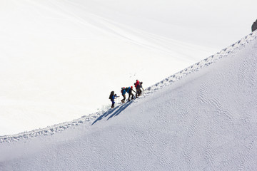 Climbing a group of climbers on a snow-covered ridge. Close-up