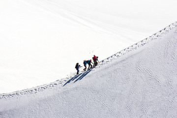 Climbing a group of climbers on a snow-covered ridge. Close-up