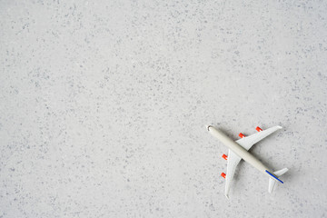 Time to travel concept. plastic plane jet toy passenger with alarm clock