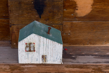 Obraz na płótnie Canvas Wooden model of the house on a background of wood