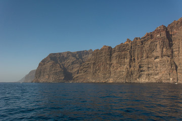 Fototapeta na wymiar Sheer steep cliffs rising above the sea.