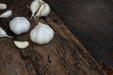 Top view of herbal vegetable ingredients, fresh garlic, on old wooden table, cooking preparation concept