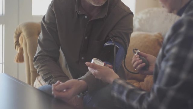 Unrecognized old woman measures the pressure to her mature husband. Mature couple spends time together. Wife cares about the health of her husband. S-log, ungraded