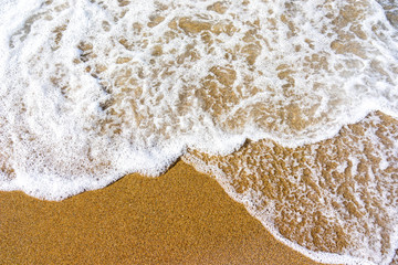 Fototapeta na wymiar Soft wave of blue sea on sandy beach.