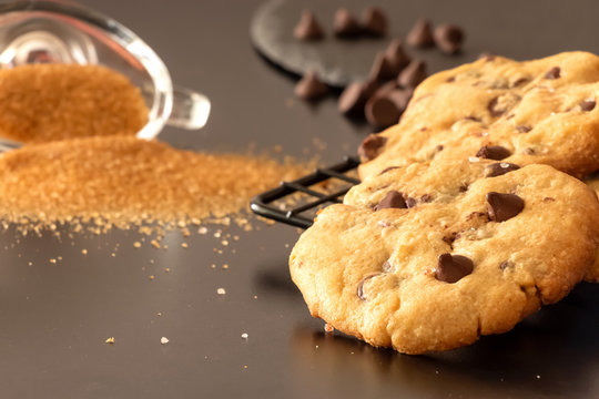 Homemade salted caramel chocolate chips cookies. Dark background.