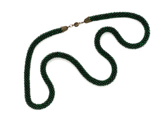 Dark green beaded necklace isolated on white background close up