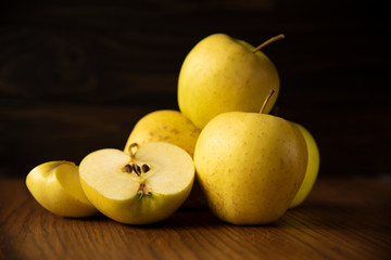 Yellow apple on the wooden vintage background