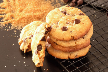 Homemade salted caramel chocolate chips cookies. Dark background.