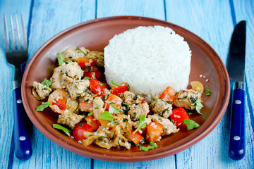 Chicken stir fry with vegetables and sesame served with rice