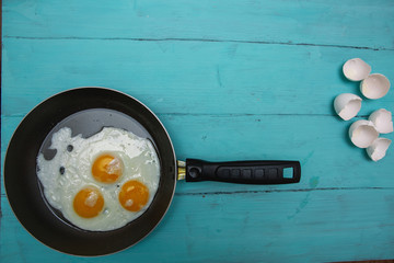 fried eggs on a wooden table