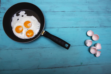 fried eggs on a wooden table