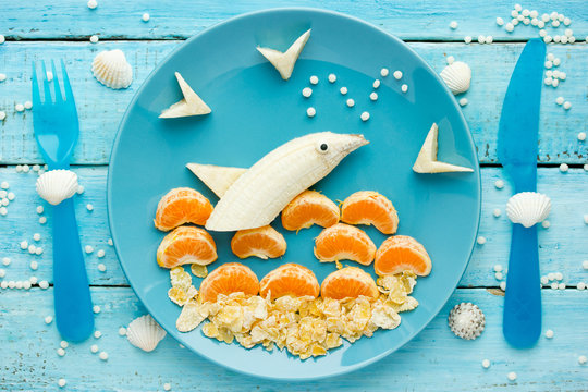 Fun and healthy food for kids - fruit dolphin, summer season and sea vacation edible concept