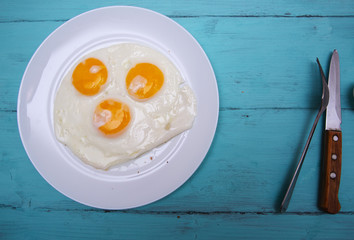 fried eggs on a wooden table