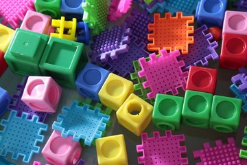 Pile of colored toy bricks isolated on white background 