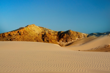 Fototapeta na wymiar Untouched sand dunes and stormy sky.