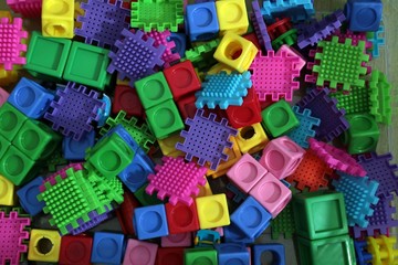 Pile of colored toy bricks isolated on white background