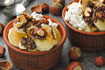 Keto breakfast or dessert. Cottage cheese with banana, hazelnuts and chocolate paste. Keto diet.