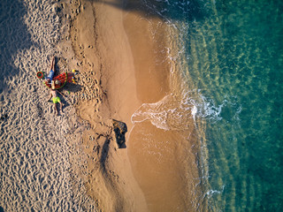 Beautiful beach with family top view shot