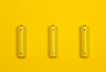 Yellow AAA alkaline batteries colorful background