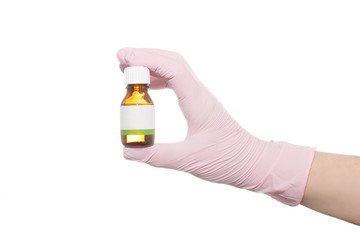 Naklejka premium Hand in a pink medical glove on a white background.
