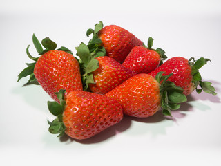 Heap of fresh red strawberries on white background
