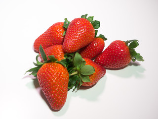 Pile of fresh red strawberries on white background