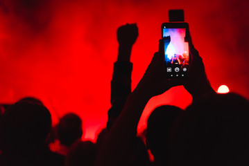 spectators at a concert phone close-up live broadcast