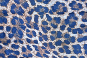 Blurred pleated fashion fabric with leopard colorful seamless print. Background with animal...