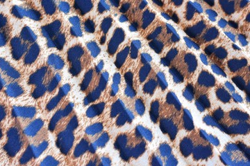 Blurred pleated fashion fabric with leopard colorful seamless print. Background with animal...