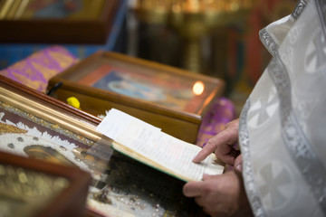 The hands of the priest hold the bible. Orthodox father