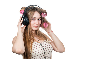 woman in hair curlers with headphones