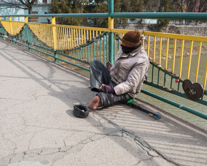  Poor beggar without leg asking for alms