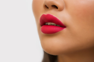 Closeup of red lips of woman with bright lipstick