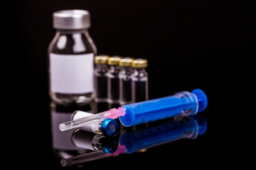 Sterile medical vials with medication solution, ampoules and syringe