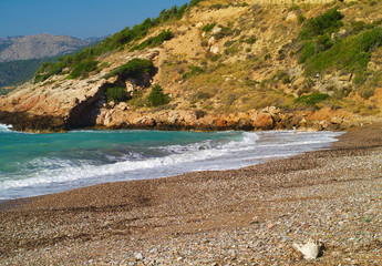 Fototapeta na wymiar Didyma (literary means twin) beach in Chios island, Greece. Beautiful isolated stone beach with no people.