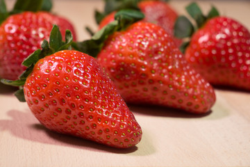Fresh red strawberries on wooden table. Close up.