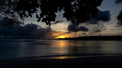 Fototapeta na wymiar Palau sunset over a secluded beach. Palau's Rock Islands are scenic, especially when enjoyed over a week long sea kayaking and camping trip.