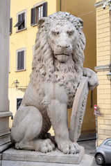 Stone lion holding shield outside of the of Basilica of Santa Croce (Basilica of the Holy Cross) in Florence, Italy