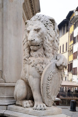 Stone lion holding shield outside of the of Basilica of Santa Croce (Basilica of the Holy Cross) in Florence, Italy