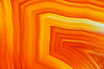 Cross section of natural translucent agate crystal surface, Orange abstract structure slice mineral stone macro closeup