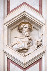Fototapeta na wymiar Saint Matthew the Evangelist, relief on the facade of Basilica of Santa Croce (Basilica of the Holy Cross) - famous Franciscan church in Florence, Italy
