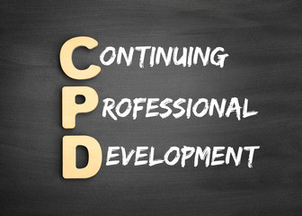 Wooden alphabets building the word CPD - Continuing Professional Development acronym on blackboard