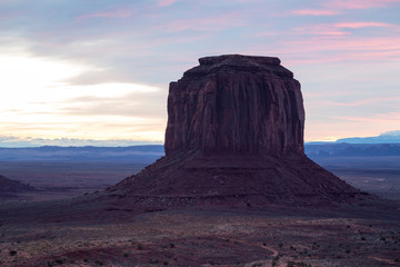 Fototapeta na wymiar The Merrick Butte in Monument Valley Navajo Tribal Park at sunrise against thin coloured clouds, Utah-Arizona border