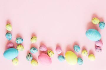 Fototapeta na wymiar Painted easter eggs lying on pink background