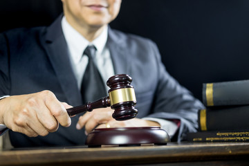 justice and law concept.Male judge in a courtroom working on wood table with documents., attorney court judge justice gavel legal legislation concept.