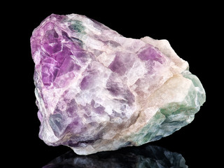 Amazing colorful macro closeup of rainbow fluorite mineral specimen isolated on black background....