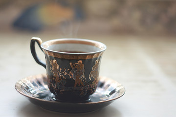 A cup of hot coffee on the table