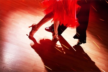 Man and a woman dancing Salsa on background