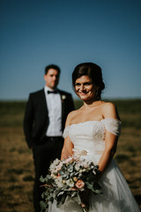 bride and groom in the field