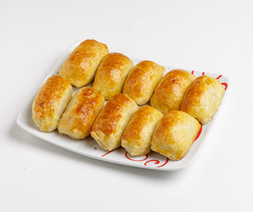 Baking with meat on a plate on a white background.